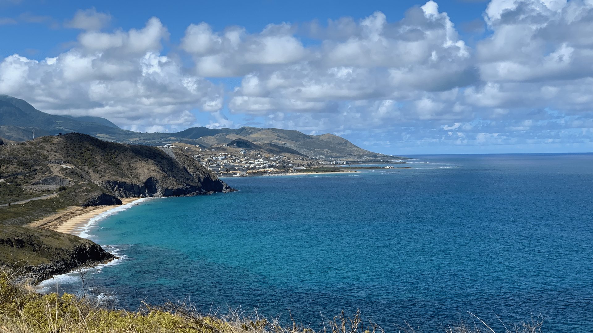 Caribbean coastline seen from a hillside above the water